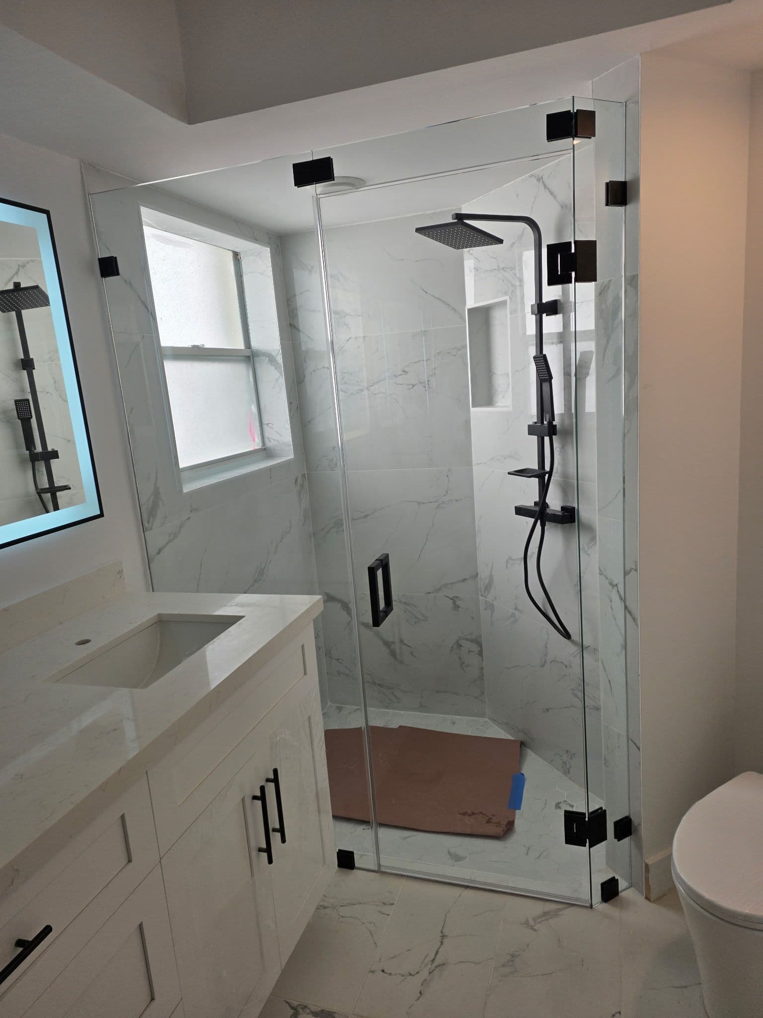 Elegant Bathroom Remodel with Marble-Tiled Design