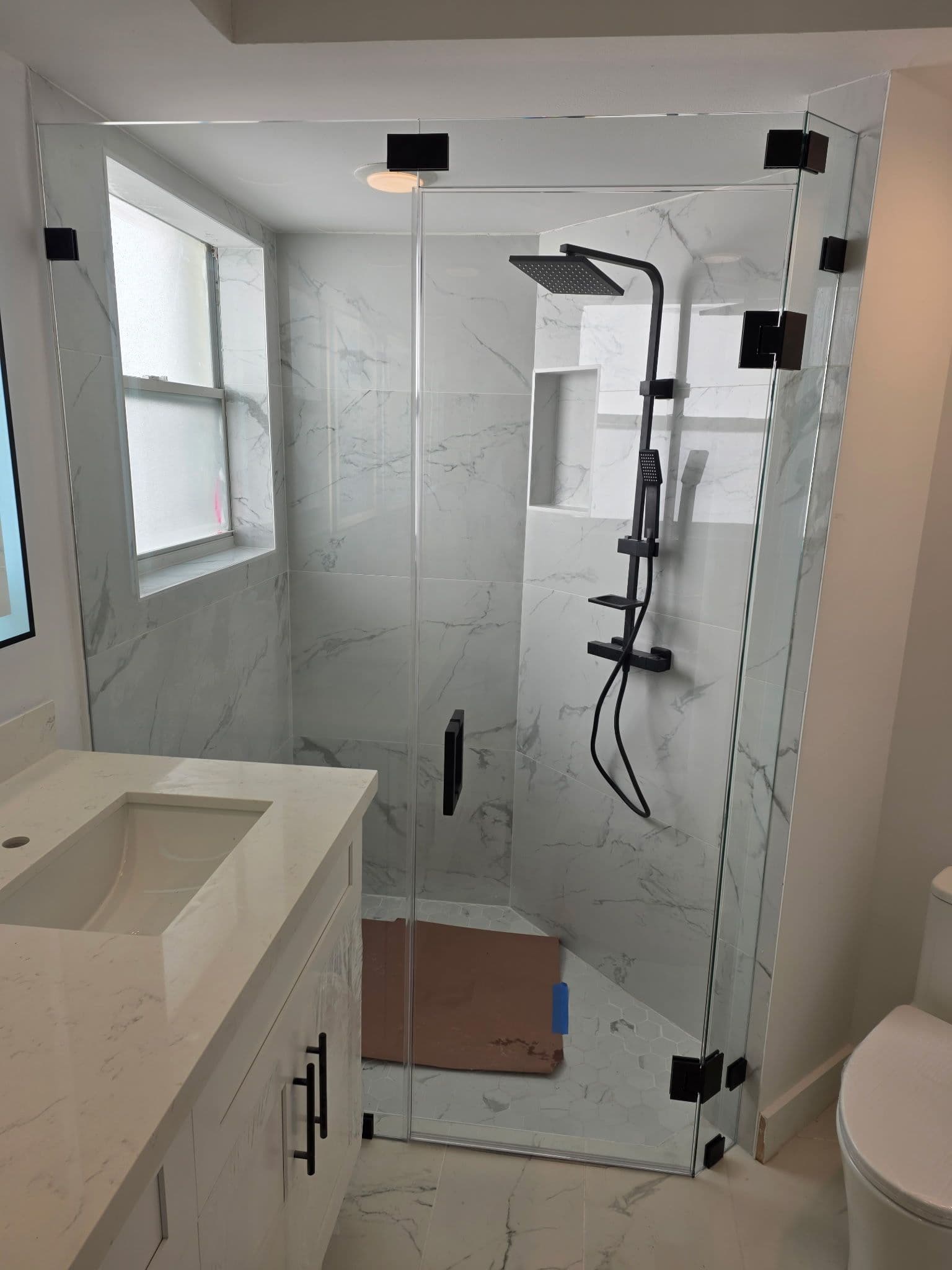 Elegant Bathroom Remodel with Marble-Tiled Design