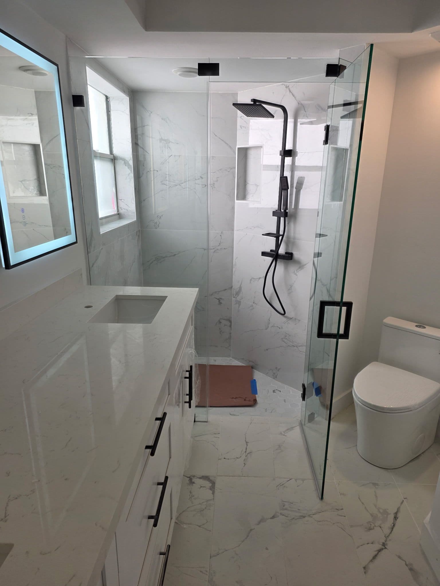 Elegant Bathroom Remodel with Marble-Tiled Design