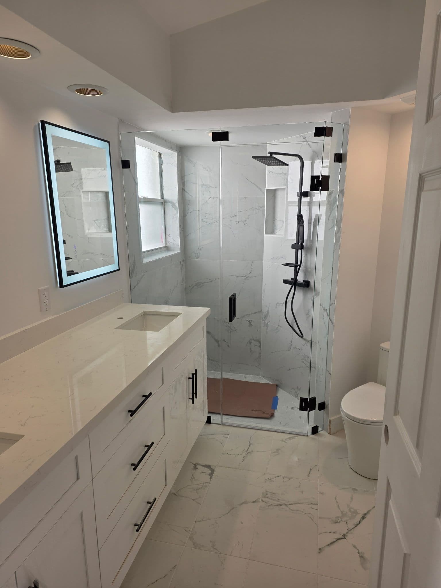 Elegant Bathroom Remodel with Marble-Tiled Design